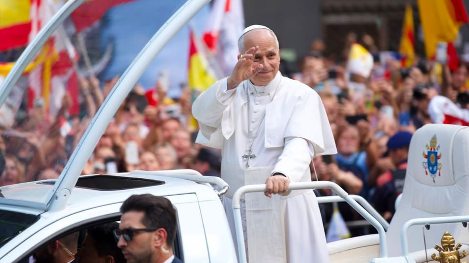 Mayor Jaume Collboni and Pope Leo XIV shaking hands at a formal event in Barcelona, with the Olympic Stadium of Montjuïc in t