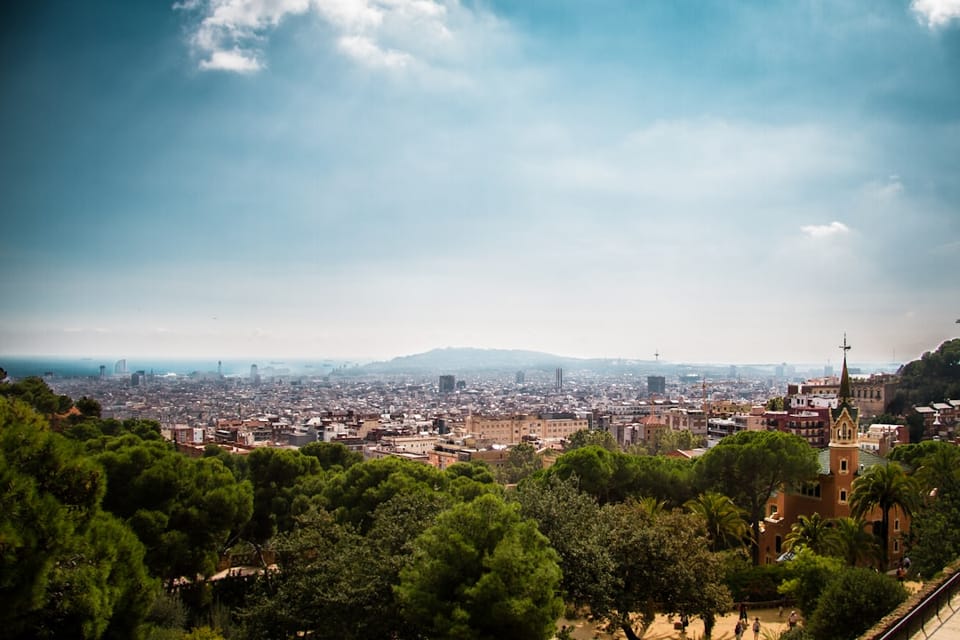 Barcelona skyline under blue sky with scattered white clouds