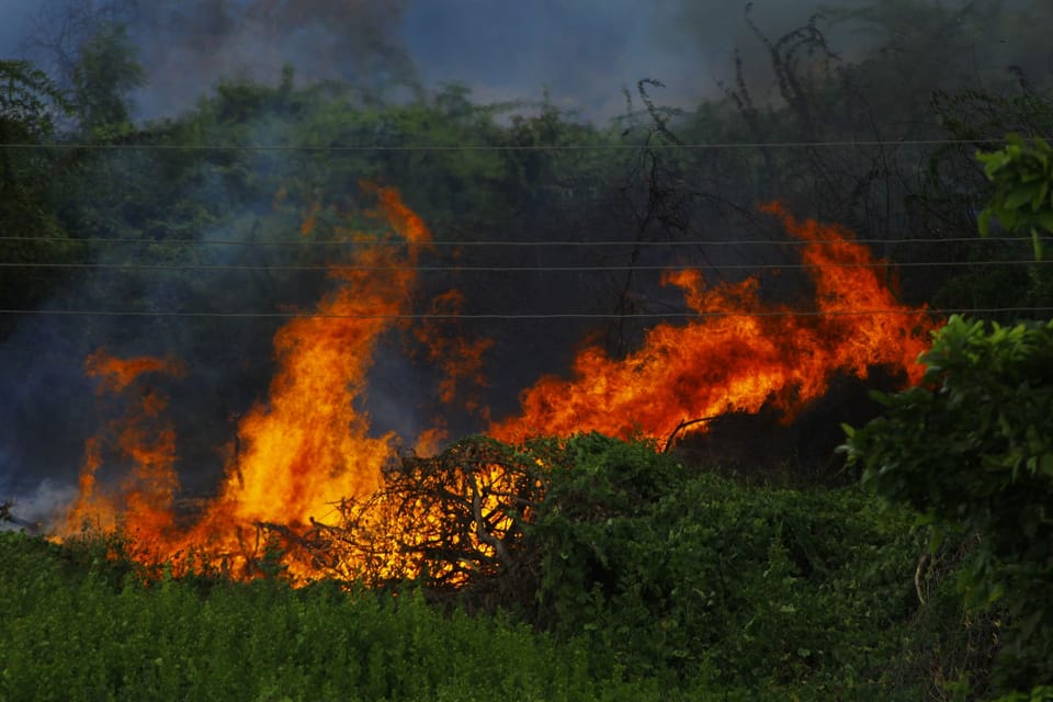 Firefighting crews work on a wildfire in the Anoia area of Catalonia after confinement orders were eased.
