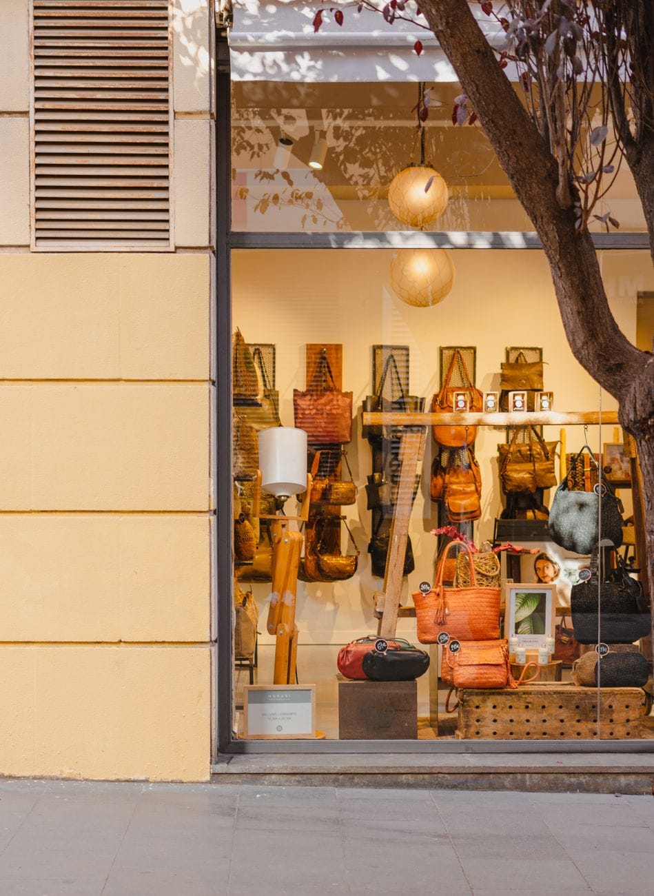 Shoppers and storefronts on a commercial street in Barcelona during the city’s 2026 local commerce programme.
