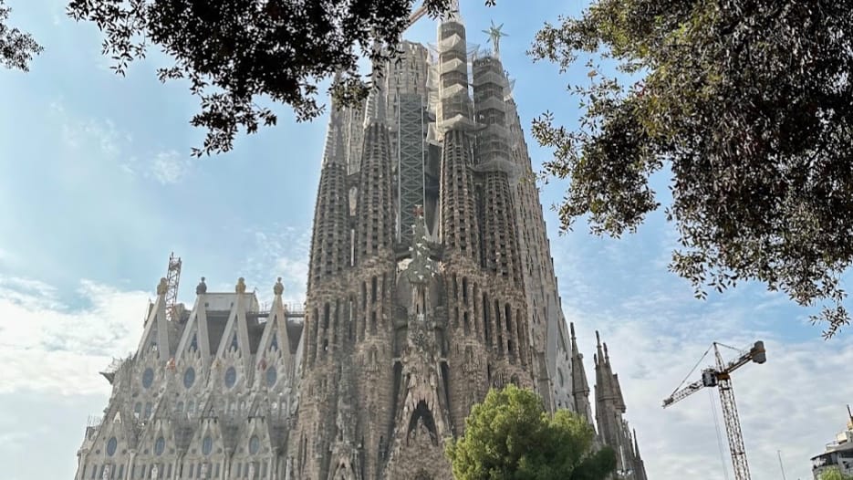 Visitors walk near the Sagrada Família basilica and its surrounding public space in Barcelona.