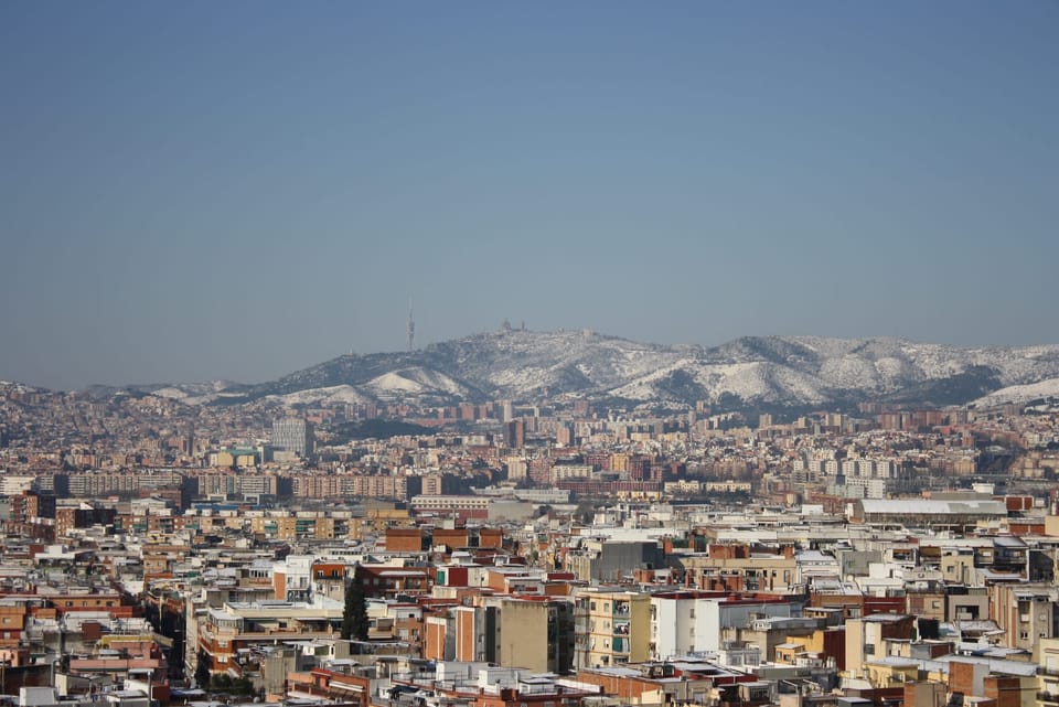 Snow-dusted rooftops and the Collserola hills after a rare snowfall in Barcelona