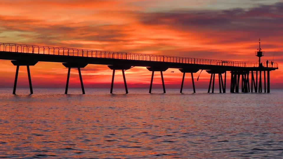 A floating construction platform is positioned beside Badalona's Pont del Petroli for reconstruction work from the sea.
