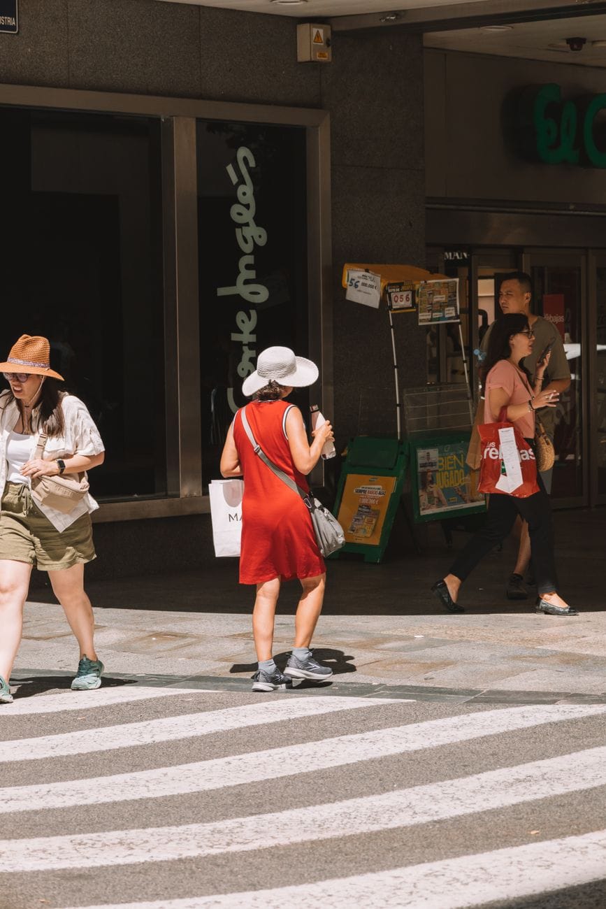 Two women shelter from extreme heat on a street in Malaga during Spain's summer heatwave.