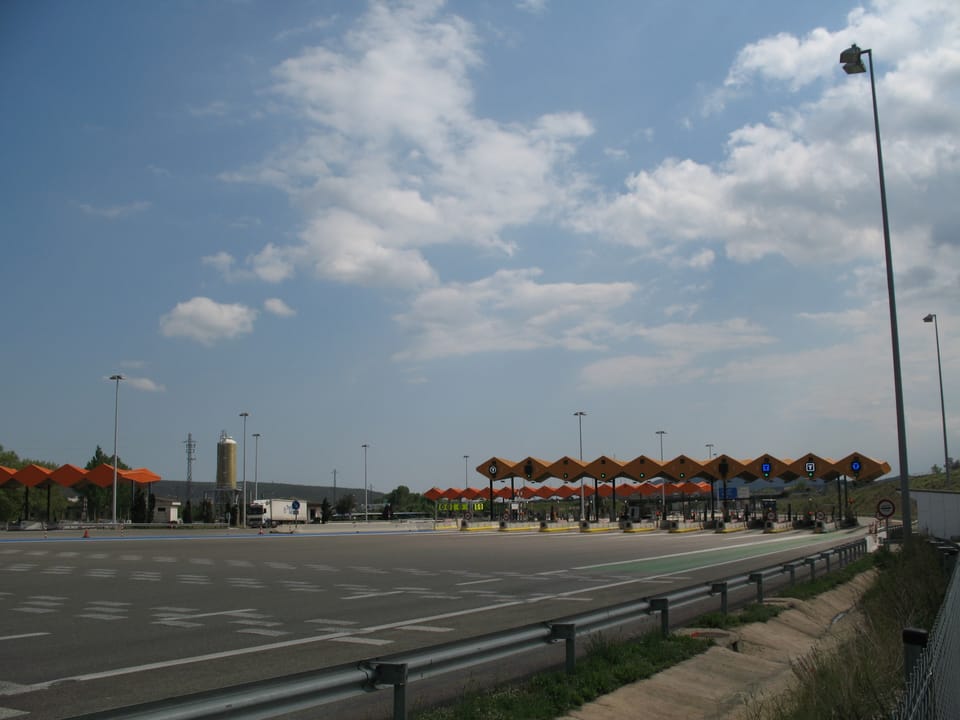 Aerial view of heavy traffic congestion on the AP-7 motorway near Barcelona, with vehicles moving slowly under overcast skies.