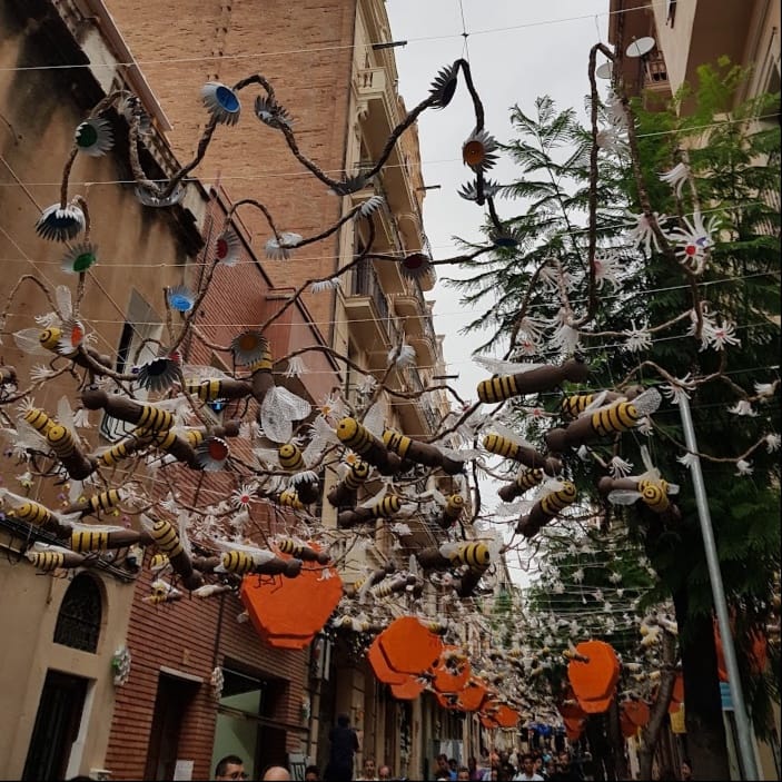 Outdoor bar terrace tables and chairs in Barcelona’s Gràcia neighbourhood during the Festa Major period.