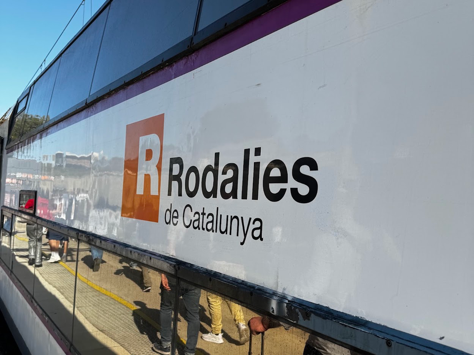 A Rodalies commuter train at a station in Catalonia, illustrating Renfe’s new real-time journey-planning app.