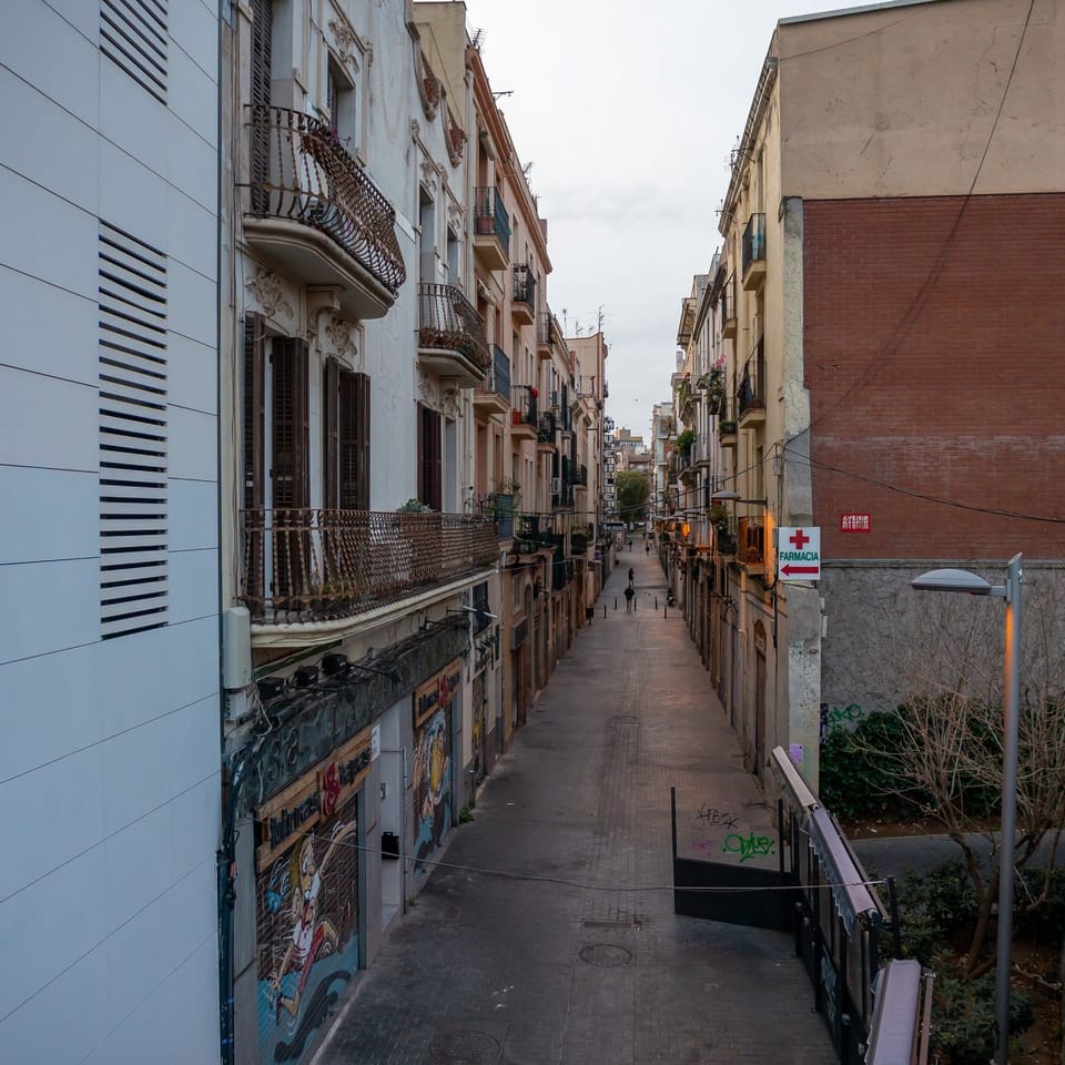 A Mossos d'Esquadra patrol vehicle parked on a residential street in the Sants neighbourhood of Barcelona.