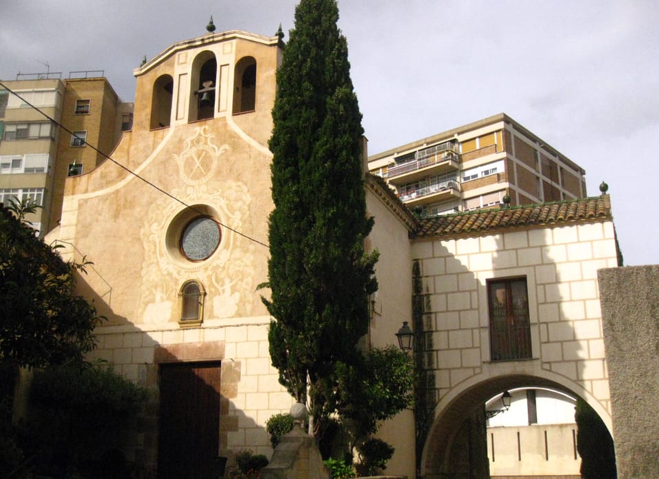 Exterior of the Santa Eulàlia de Vilapicina sanctuary in Barcelona's Nou Barris district, a neoclassical church with stone façade and arched windows.