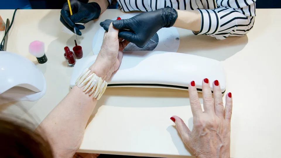 A row of beauty and nail salons on a Barcelona street, with signs in Catalan and Spanish advertising manicures and aesthetic services.