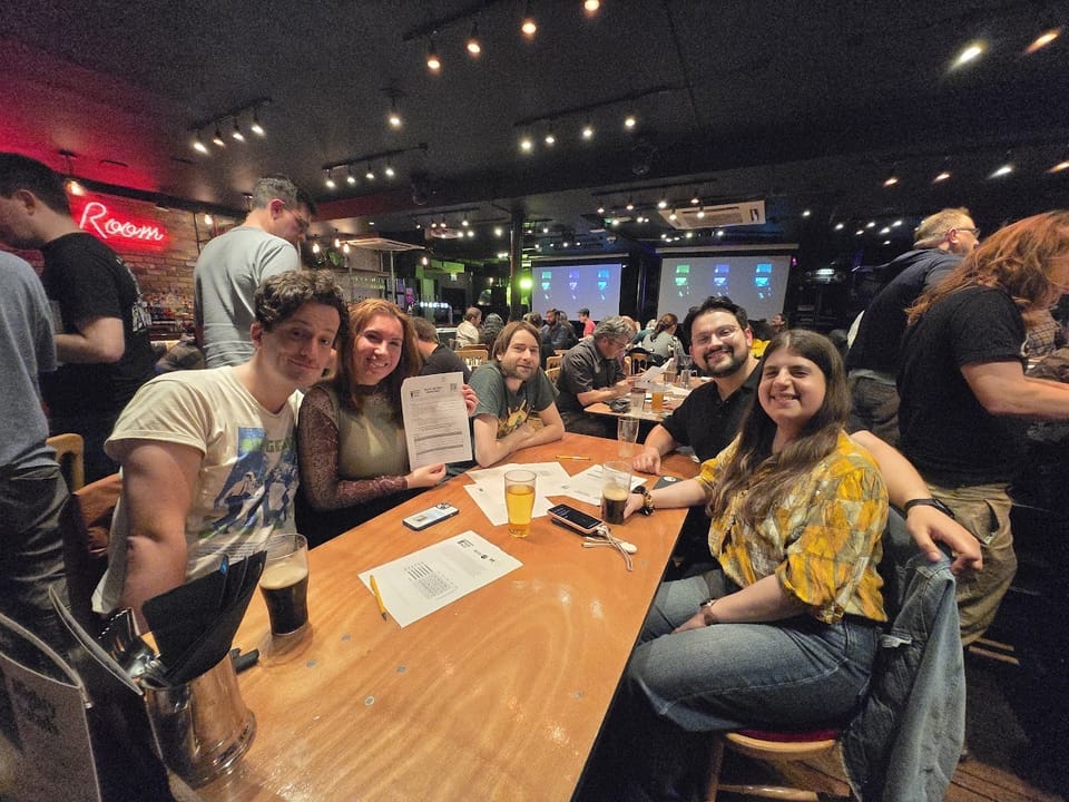Solvers working through a puzzle packet at a Puzzled Pint event