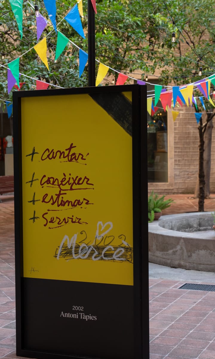 Exhibition of 48 official La Mercè festival posters displayed in the courtyard of the Frederic Marès Museum in Barcelona.
