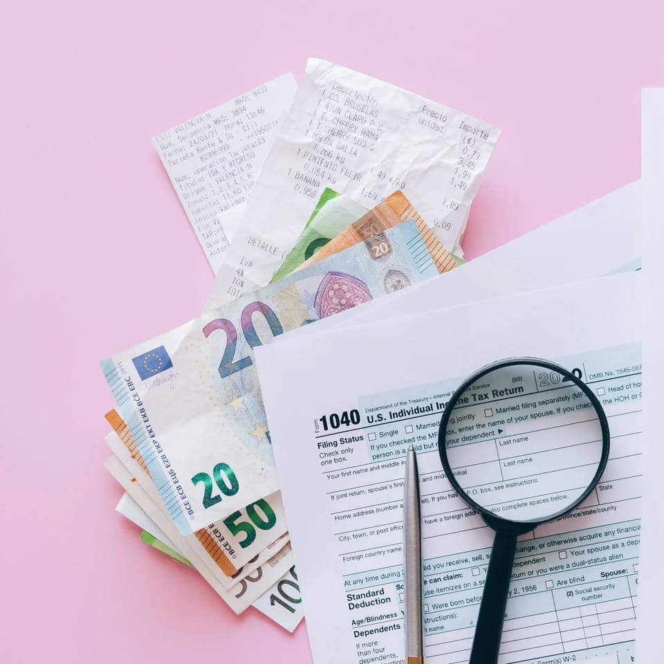 Tax and accounting paperwork with a calculator on a desk