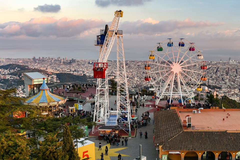 Aerial view of Tibidabo Amusement Park perched on a hilltop with panoramic views over Barcelona and the Mediterranean Sea during the La Mercè festival.