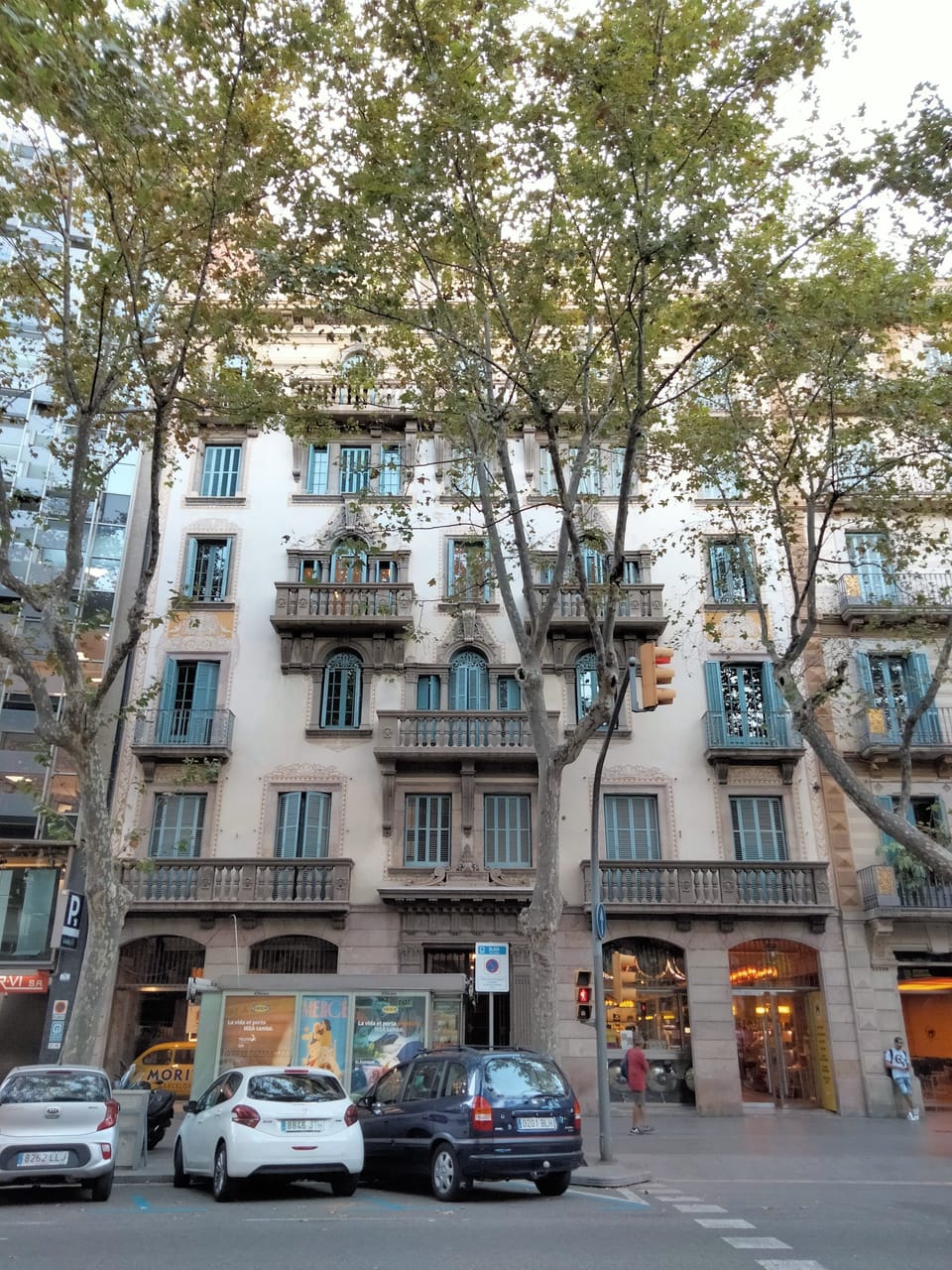 A narrow street in Barcelona's Eixample district near Passatge de Lluís Pellicer, lined with residential buildings and protest banners calling to stop evictions.