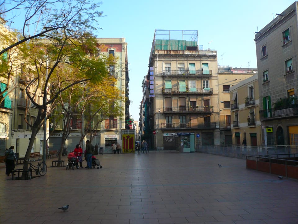 Aerial view of Plaça de la Revolució de Setembre de 1868 in Gràcia, Barcelona, showing the surface level above the underground car park affected by water leaks.