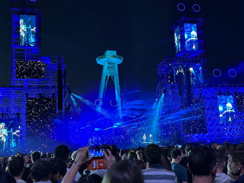 Palau Sant Jordi in Barcelona illuminated at night, hosting major concerts and events.