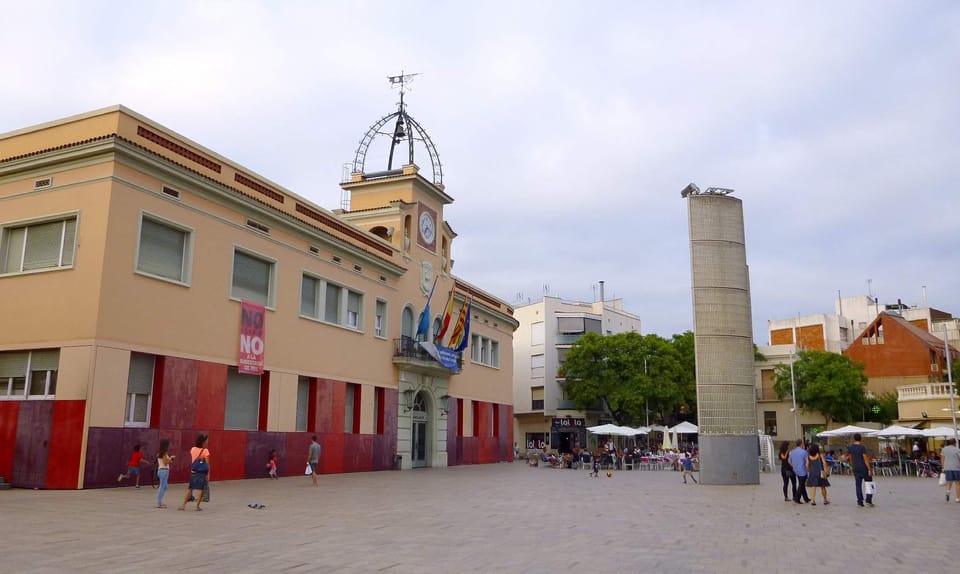 A busy street in Santa Coloma de Gramenet with local shops and pedestrians, illustrating the urban commercial environment affected by the new moratorium.
