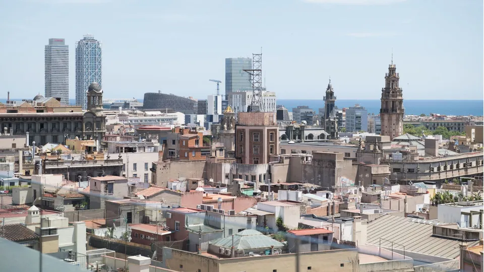 Apartment buildings on a residential Barcelona street, illustrating the city's rental market.