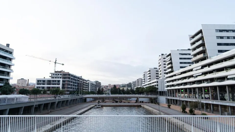 A modern residential building with many balconies, representing public housing in a city environment.