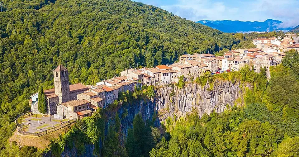 Castellfollit de la Roca village perched on a tall basalt cliff with houses at the edge