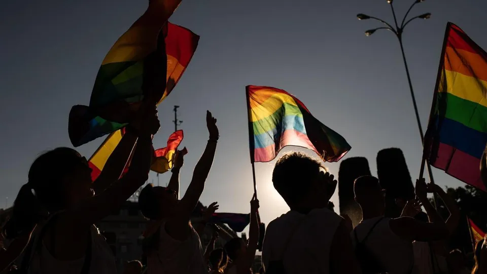 Rainbow flag flying over a municipal building in L'Hospitalet de Llobregat, symbolising LGBTI rights and diversity.