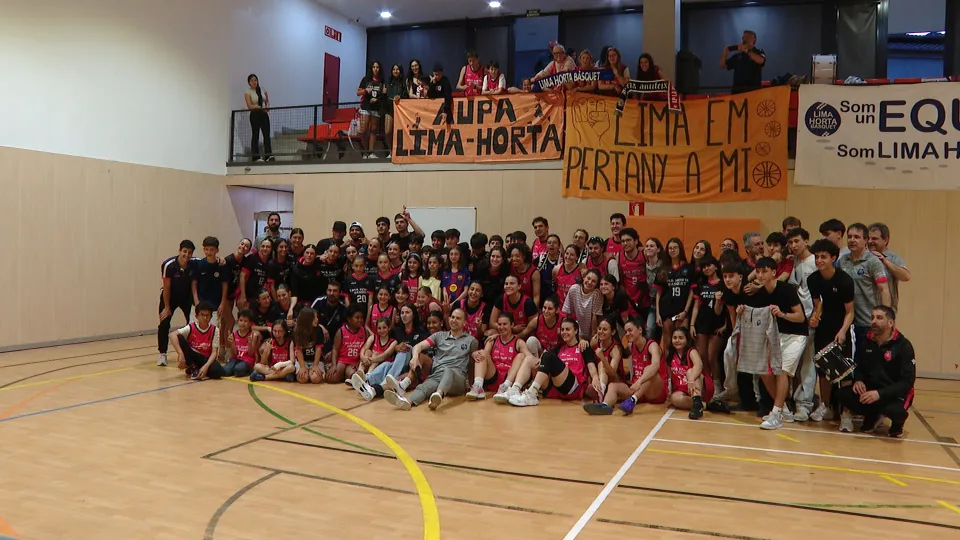Lima Horta women's basketball team celebrating on court with fans