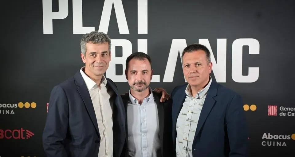 Three chefs, Oriol Castro, Eduard Xatruch, and Mateu Casañas, standing proudly in a professional kitchen, possibly at Disfrut