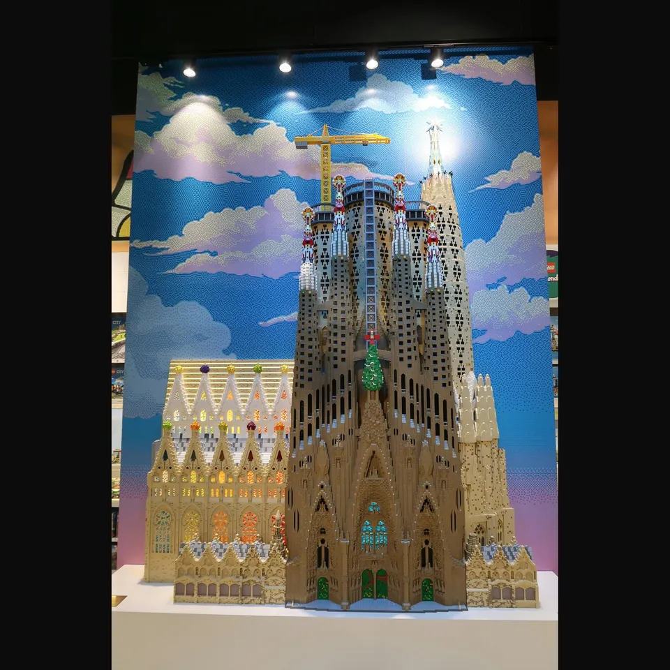 Children building with LEGO bricks inside the flagship store on Passeig de Gràcia in Barcelona during a weekend celebration event.